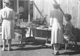 Grace Flather (seated right) serving tea with Lawren Harris's Wife, Bess Harris at BC Binnings West Vancouver home in the 1940's at an Annual Federation of Canadian Artists party.